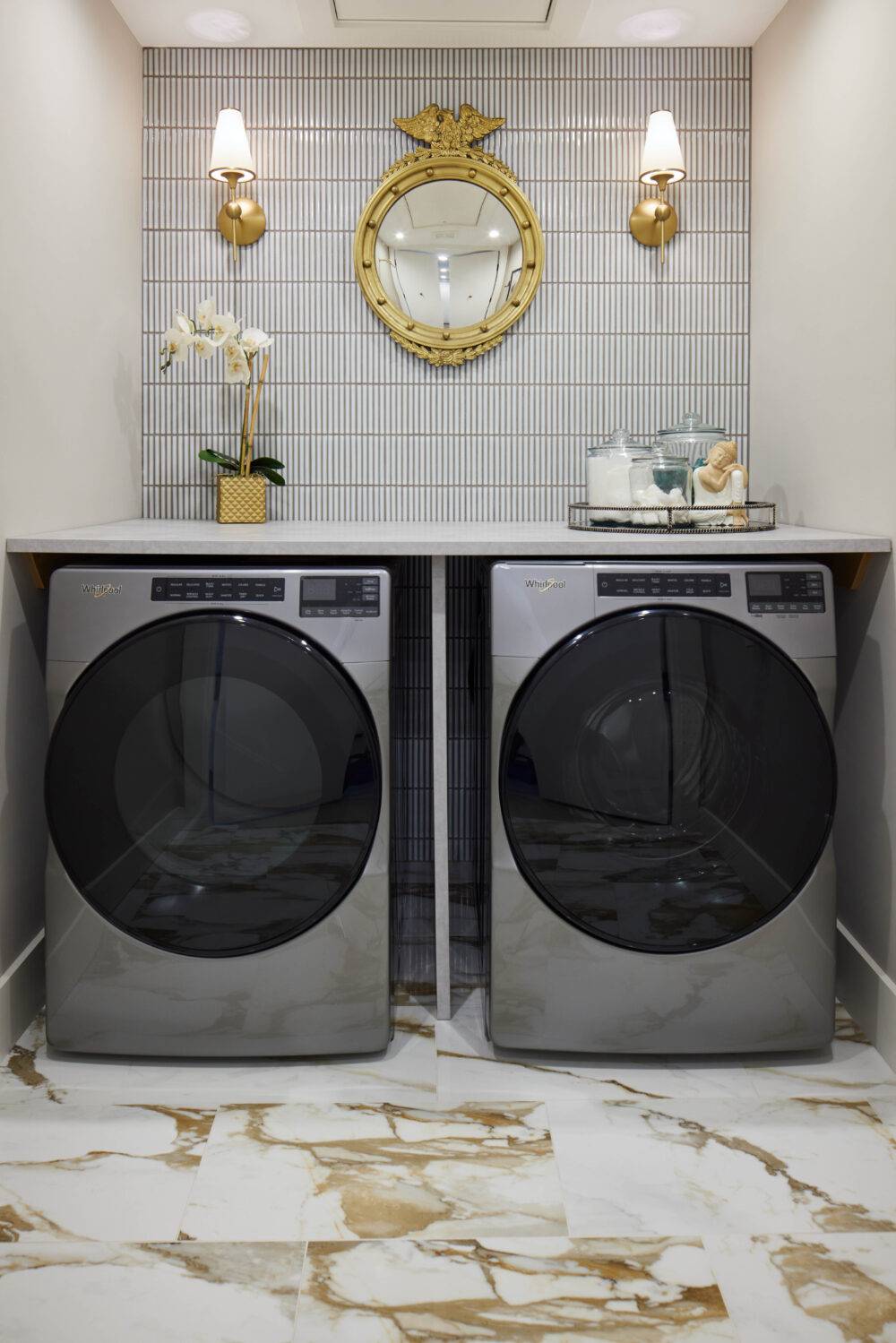 Laundry room with white handmade-look mosaic tile wall and white with dramatic ochre and gold veining marble-look porcelain tile floor.