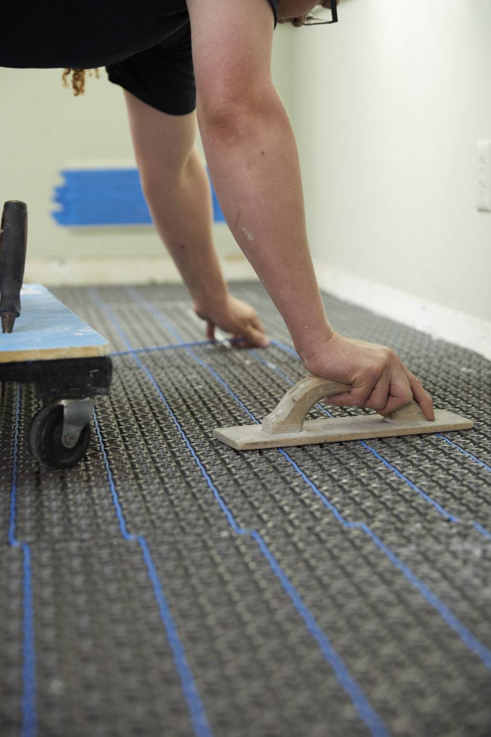 In-floor heat wire being installed in membrane