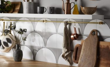 Kitchen backsplash detail shot with patterned tile and white shelf with decor