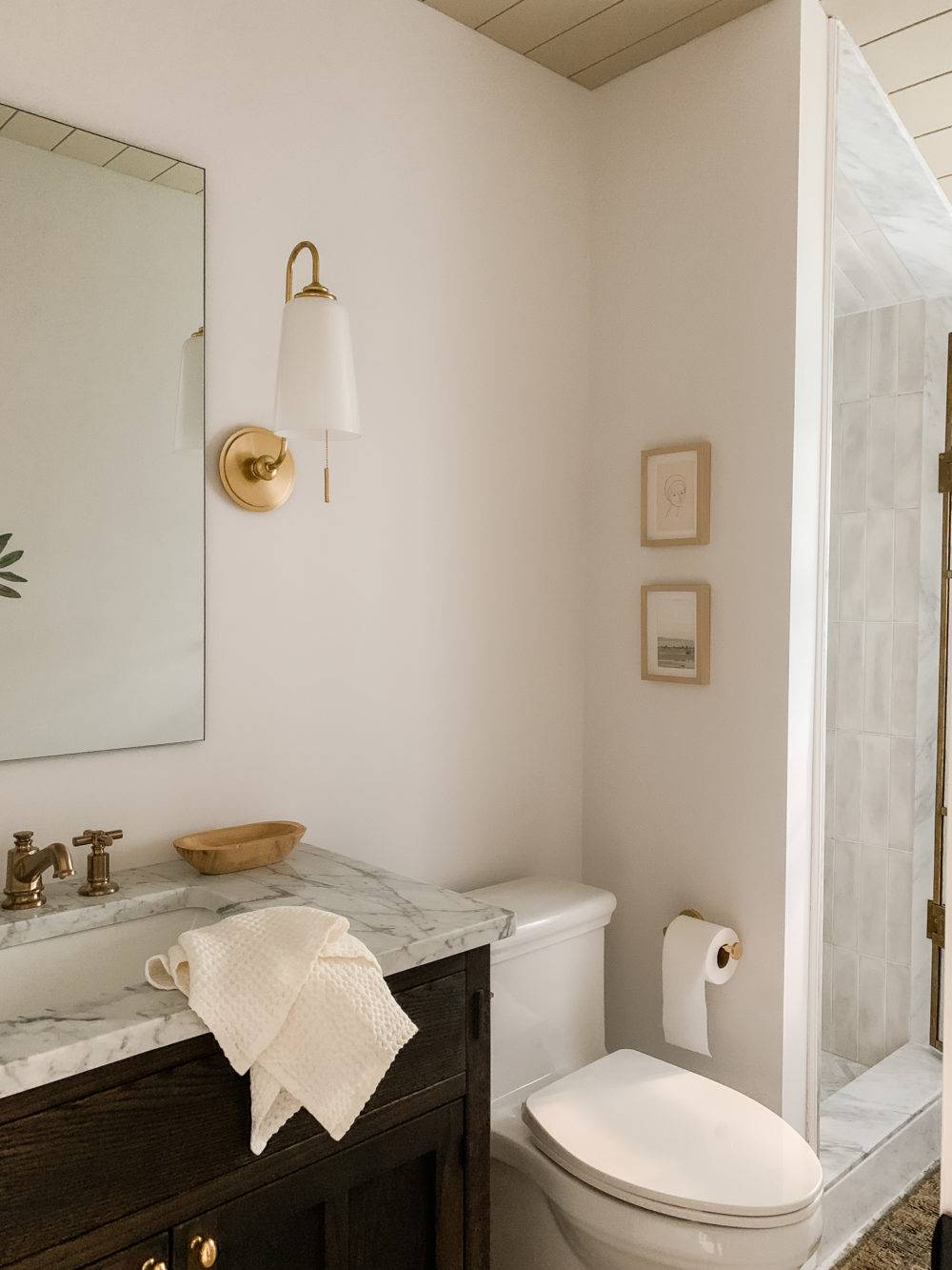 Simple bathroom with dark vanity and gold accents