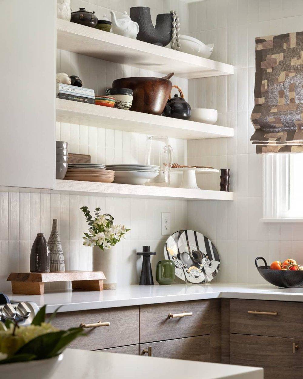 white kitchen with white subway tiled backsplash and open shelving