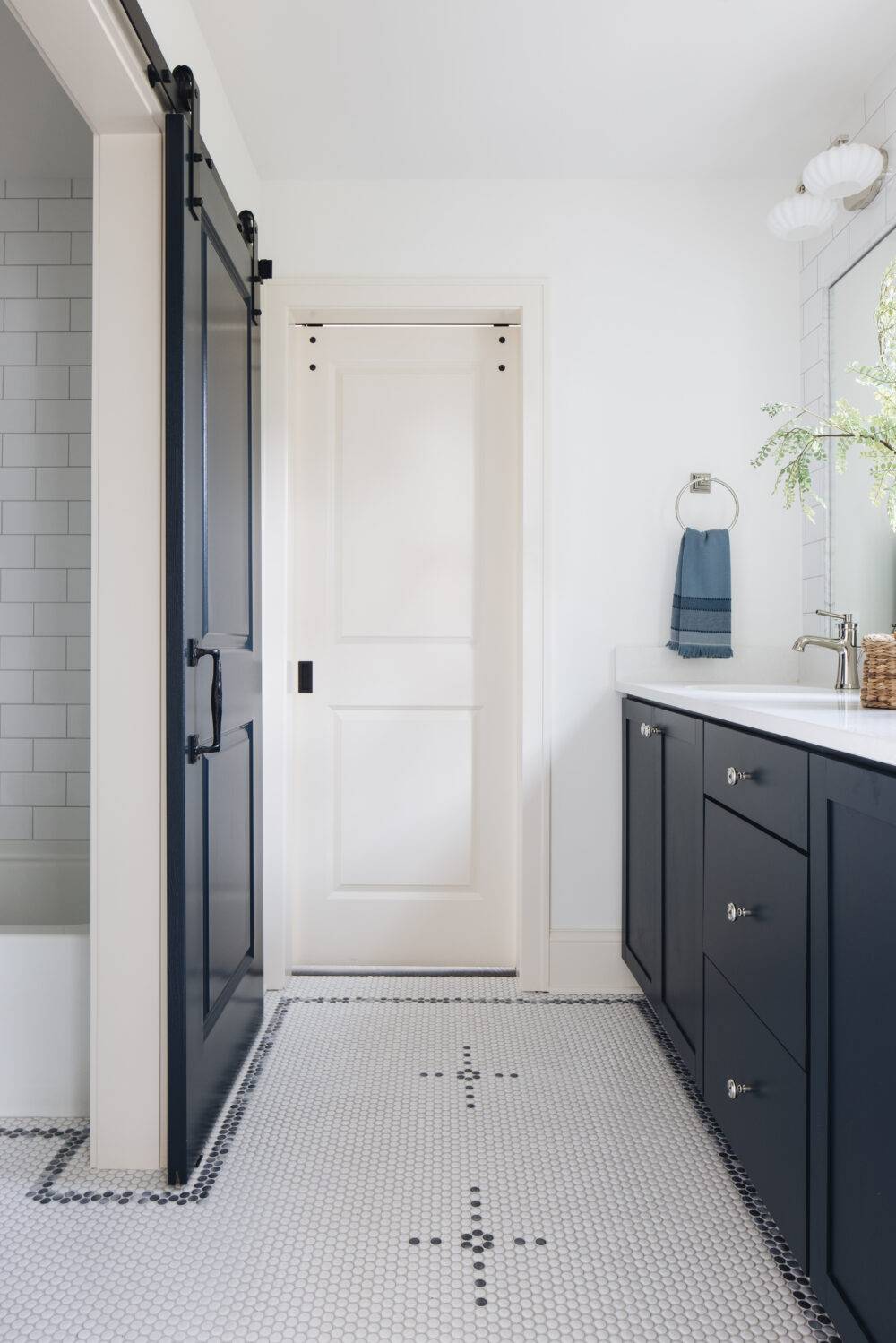 Bathroom featuring Penny Round Gloss White and Penny Round Cloudy floor tile. 