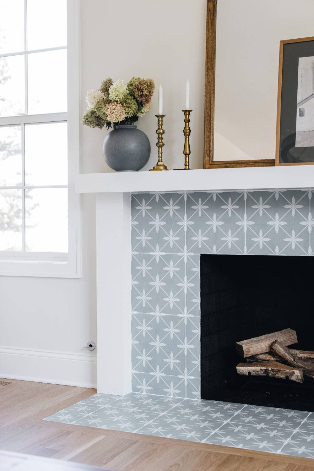 Living Room with a fireplace with Blue patterned tile for the surround.